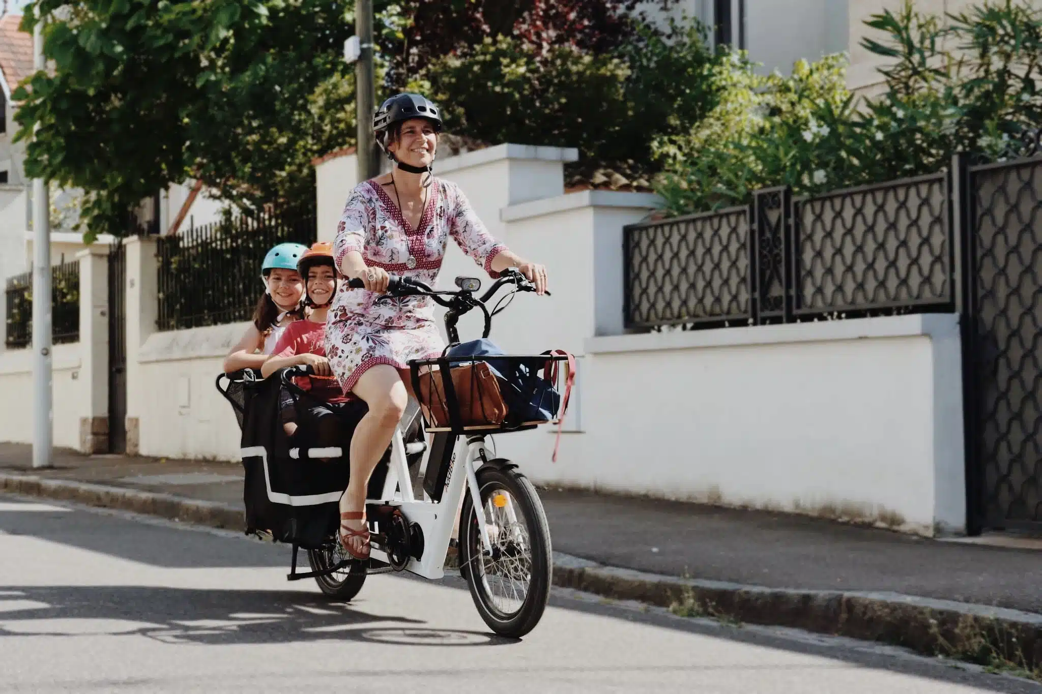 Bike family ridden by siblings and mum in a dress