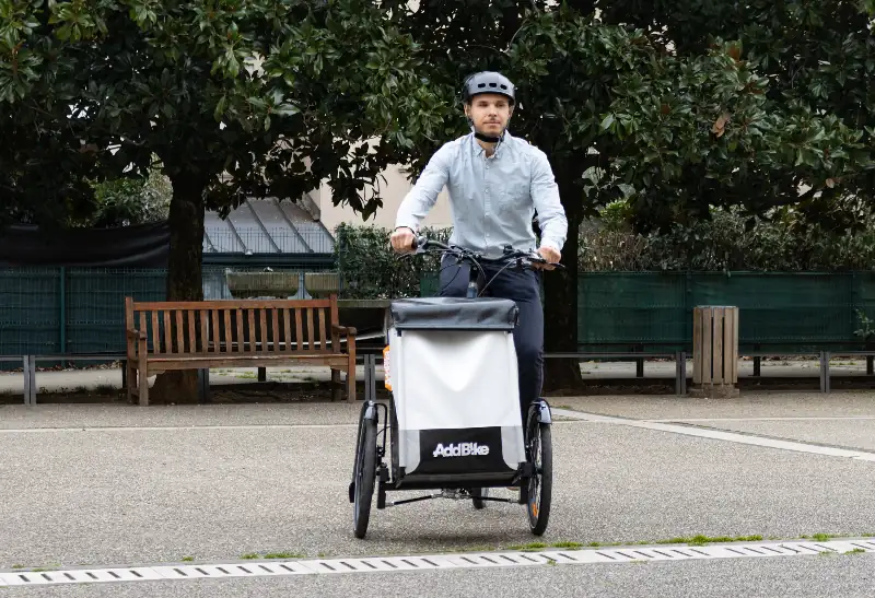 Adult trike: man steering on a tricycle with tilting wheels